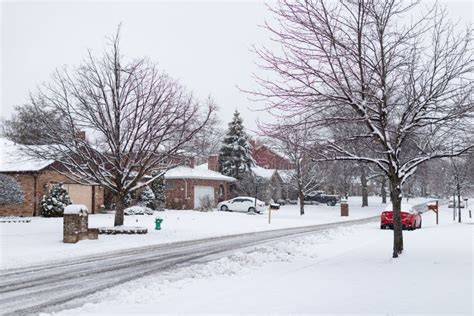 Beautiful Snow Covered Neighborhood Street With Homes During Winter In