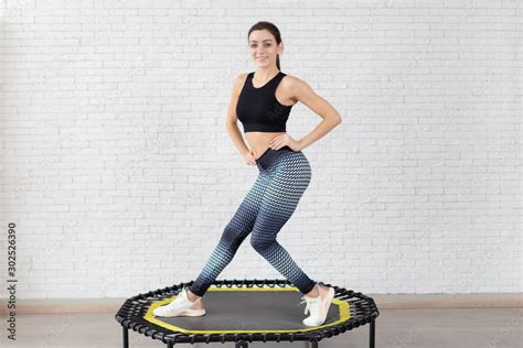 Relaxed Woman Jumping On Trampolineyoung Fitness Girl Trains On A Mini