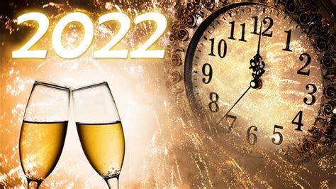 Two Glasses Of Champagne Next To A Clock With Fireworks In The Background That Reads