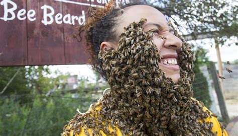 A Woman Covers Her Face With Bees During The Bee Beard Challenge Of The 2017 Honey Festival