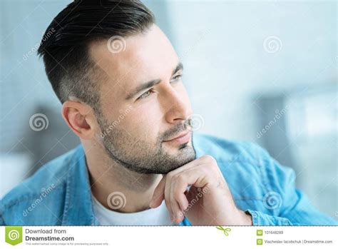 Pensive Young Man Resting His Chin On Hand While Thinking Stock Image