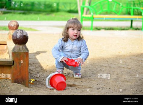 A Little Girl Playing In The Sandbox Stock Photo Alamy