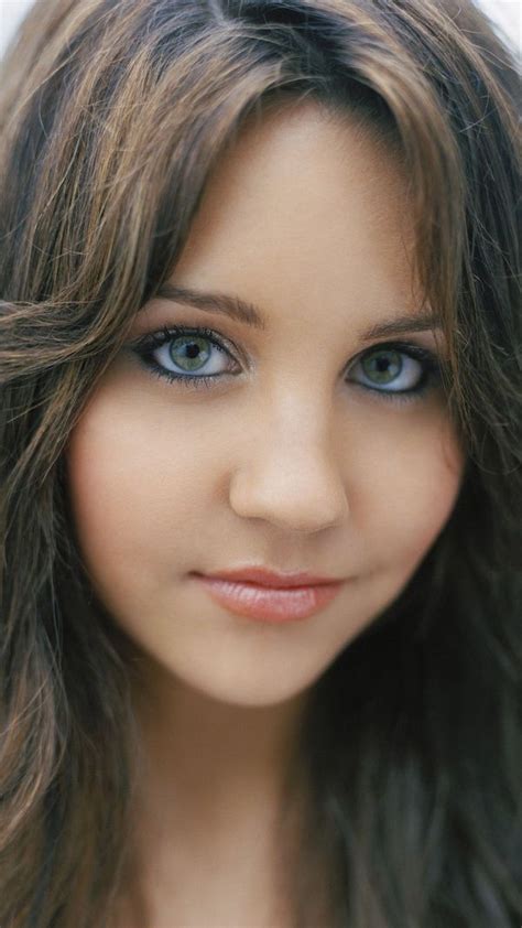 A Woman With Long Brown Hair And Blue Eyes