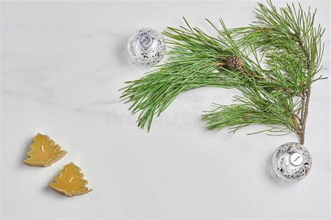 Green Pine Branch And Christmas Decorations On Marble Background Stock