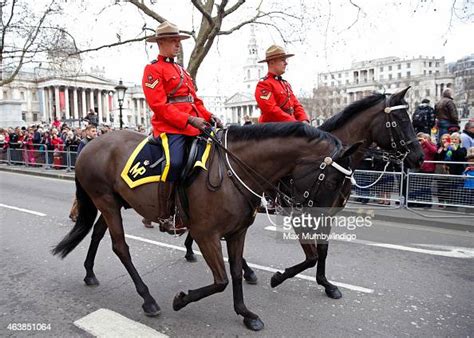 Two Royal Canadian Mounted Policemen Ride Their Horses Past Trafalgar