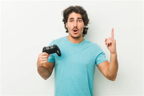 Premium Photo Young Man Holding A Game Controller Having Some Great