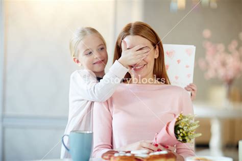 Cute Child Covering Her Mother Eyes Before Surprise Royalty Free Stock