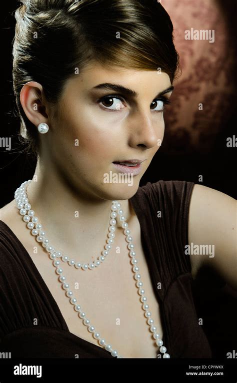 Young Woman Wearing A Pearl Necklace And Pearl Earrings Portrait Stock