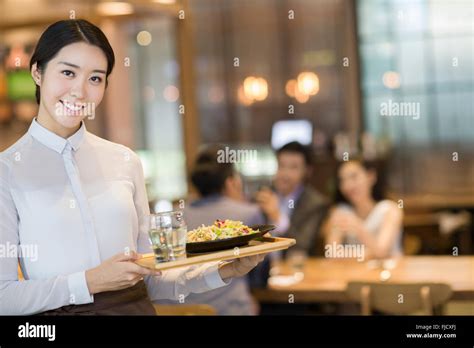 Chinese Waitress Serving In Restaurant Stock Photo Alamy