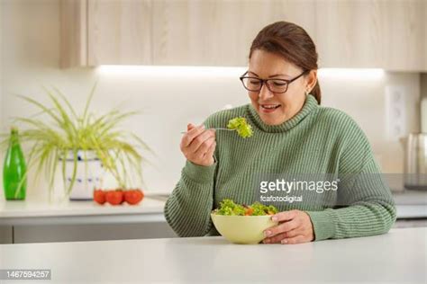 mature woman eating salad photos and premium high res pictures getty images