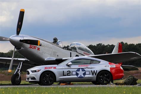 Ford Mustang Parked Beside A P 51 Mustang At Sanicole Airshow In