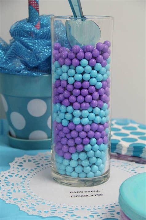 We are loving this elegant pink baby shower table! Purple and turquoise candy jars | Baby shower purple ...