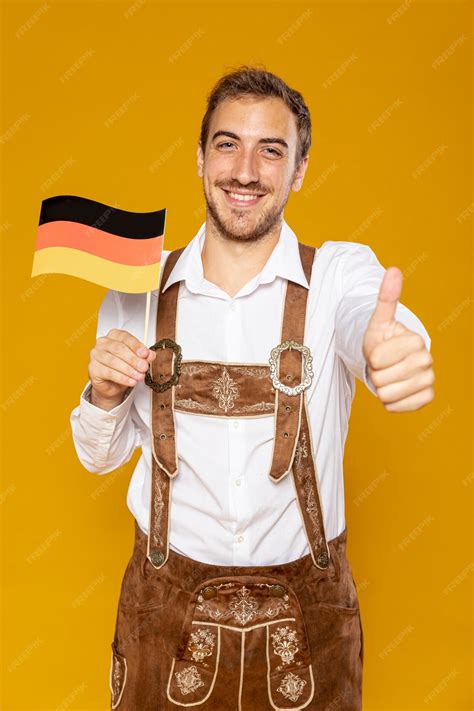 Free Photo Front View Of Man Holding German Flag