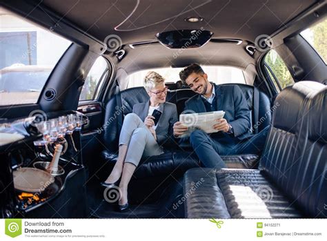 Partners In Limo Looking At Newspaper Stock Image Image Of Sitting Elegance