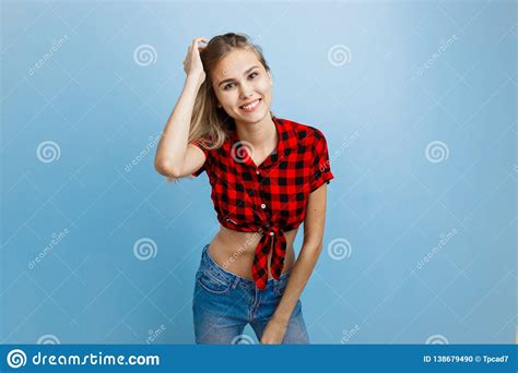 Belle Jeune Fille Blonde Joyeuse Avec Des Yeux Bleus Utilisant La Chemise Et Les Blues Jean à