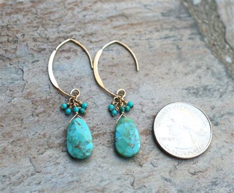 Two Kingman Turquoise Ovals Are Wire Wrapped And Dangle From Large 14KT