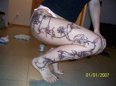 the rose vine on the leg with the black and grey work done tattoo pictures at