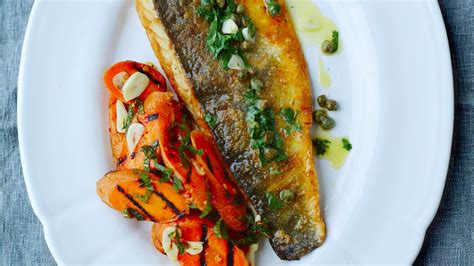 Sea Bass And Capers With Butter Sauce Served With Grilled Carrots Marinated In Garlic And White
