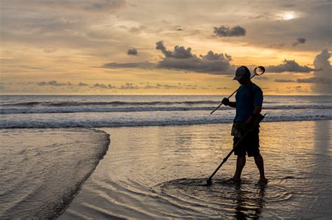 Best metal detector buying guide. Treasure Hunter On The Beach With A Metal Detector Stock ...