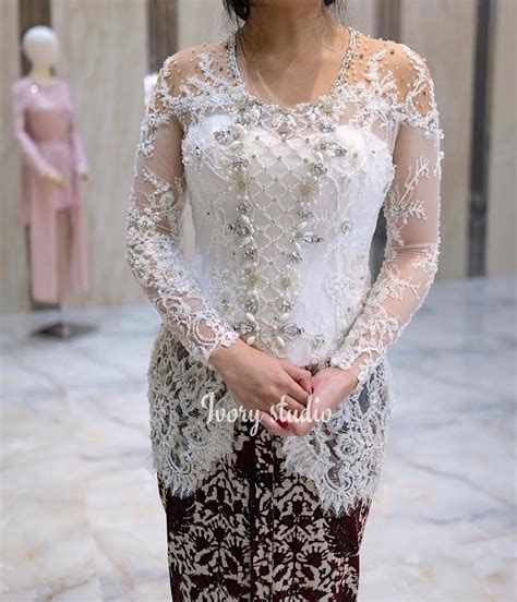 Aksesoris berupa kalung bulan suri yang berbentuk. Pin di kebaya