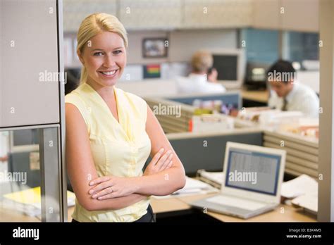 Businesswoman Standing In Cubicle Smiling Stock Photo Alamy