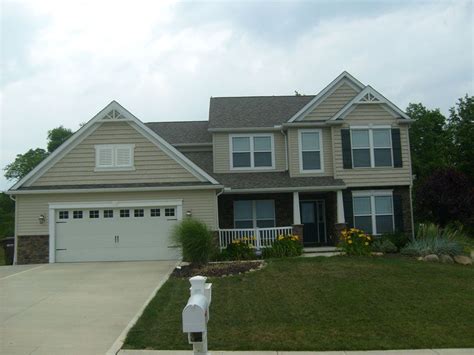 Still working on door color, because there're orange brick pillars supporting the porches, and in the landscaping. homes with tan siding and green trim | Tan Vinyl Siding ...