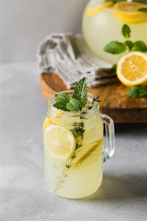 Homemade Lemonade With Fresh Lemon Slices And Mint Leaves In A Glass A