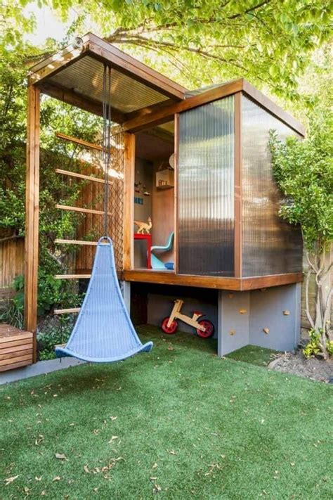 An Outdoor Play Area In The Backyard With A Swing Set And Wooden