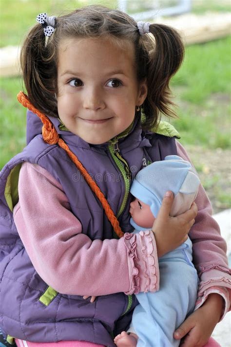 Little Girl Holding A Doll Stock Photo Image Of Affection 10030982