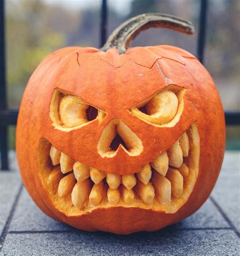 A Carved Pumpkin With Teeth And Eyes