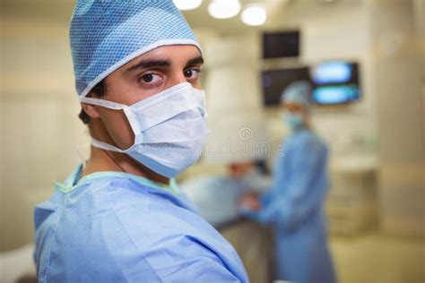 Portrait Of Male Surgeon Wearing Surgical Mask In Operation Theater