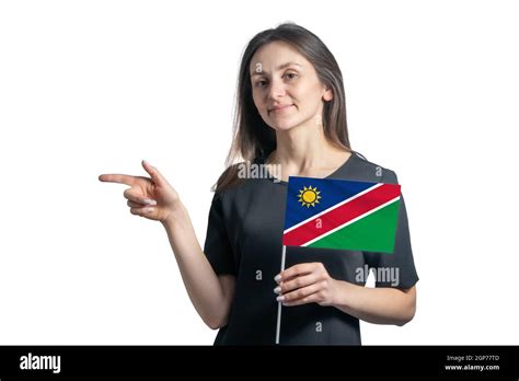 Happy Young White Woman Holding Flag Namibia And Points To The Left