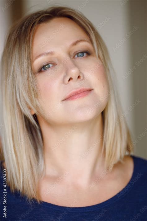 Closeup Portrait Of Beautiful Babe Middle Age Caucasian Woman In Blue Shirt Looking In Camera