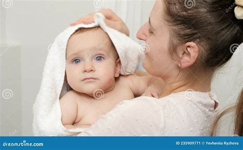 Caring Mother Wiping And Drying Her Baby Son With Towel After Washing