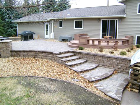 Gray Paver Patio With Edging Rocks And Plants Oasis