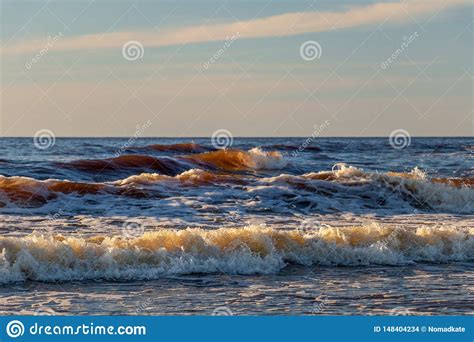 Golden Yellow Foamy Sea Waves Background At Romantic Beach Sunset With