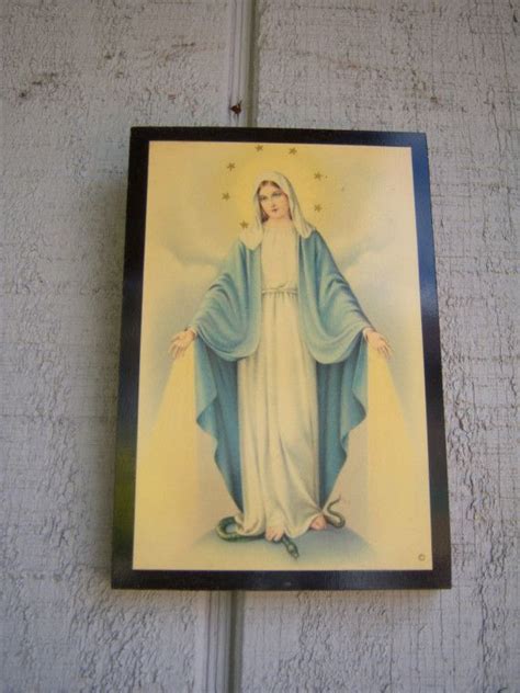 An Image Of The Immaculate Mary On A Wall