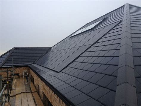 Completed GSE Roof Integrated System With Black Panels On A Slate Roof
