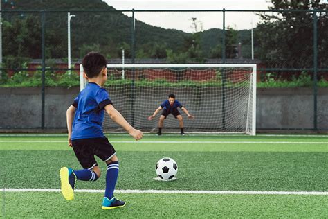 Father And Son Playing Soccer By Stocksy Contributor Maahoo Stocksy