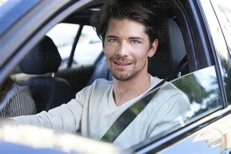 Portrait Of Confident Man Driving Car Stock Photo
