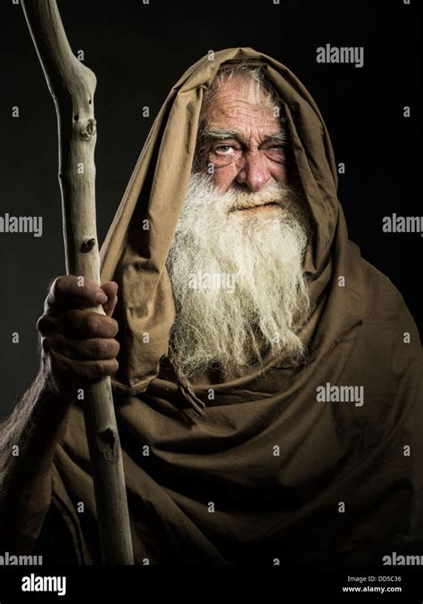 Old Man With White Beard Staff And Cloak Looks Like Wizard Gandalf