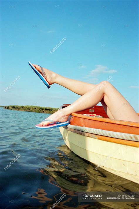 Sunbathing On A Boat Flip Flop Female Stock Photo