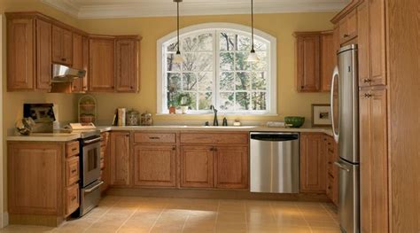 You can also refinish existing cabinets in light wood with a dark brown stain to add depth to their look. yellow walls oak cabinets | Color schemes I like ...