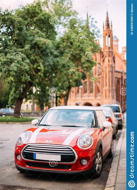 Red Color Car With White Stripes Mini Cooper Parked On Street On