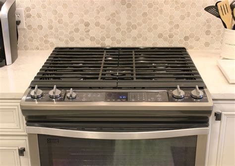Glossy greige cabinets complement this kitchen's lightly stained flooring. Bettendorf, IA- The Perfect Greige Kitchen Palette ...