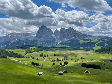 Long Shot Of A Meadow In Dolomites Italy With Houses Surrounded By