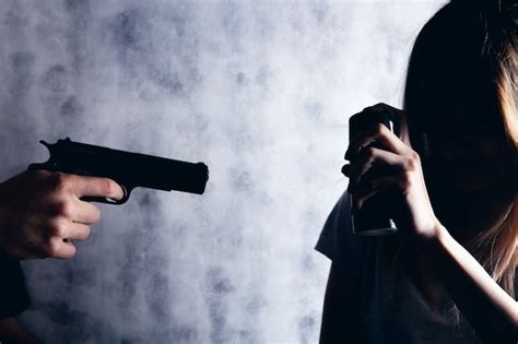 Premium Photo Woman Defend Herself With A Spray Can From An Armed Man