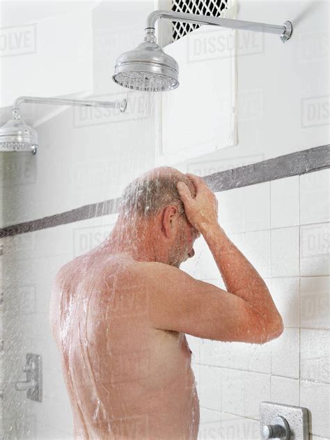 Older Man Showering In Locker Room Stock Photo Dissolve