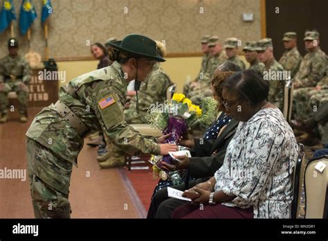 A Soldier With The Us Army Drill Sergeant Academy Hands A Bouquet Of