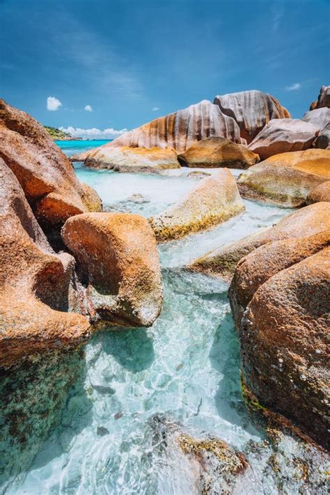 Bizarre Shaped Rocks In Blue Ocean Water On Anse Cocos Beach La Digue